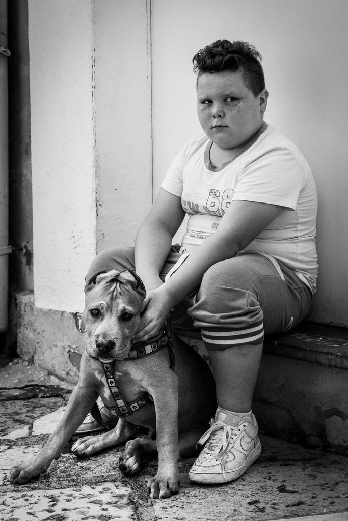 A BOY'S OWN DREAM.  This little boy, with his adorable freckles and his puppy, live in the beautiful and historic Old Town of Bari (Bari Vecchia) in Puglia. Of course I couldn’t resist taking this photograph. His mother came out and told him to, ‘Stay there for the nice lady!’ And so he did but was not a happy camper till later, when he saw himself in the back of the camera. Then he went off and continued playing with his puppy. Limited Edition Fine Art print. 